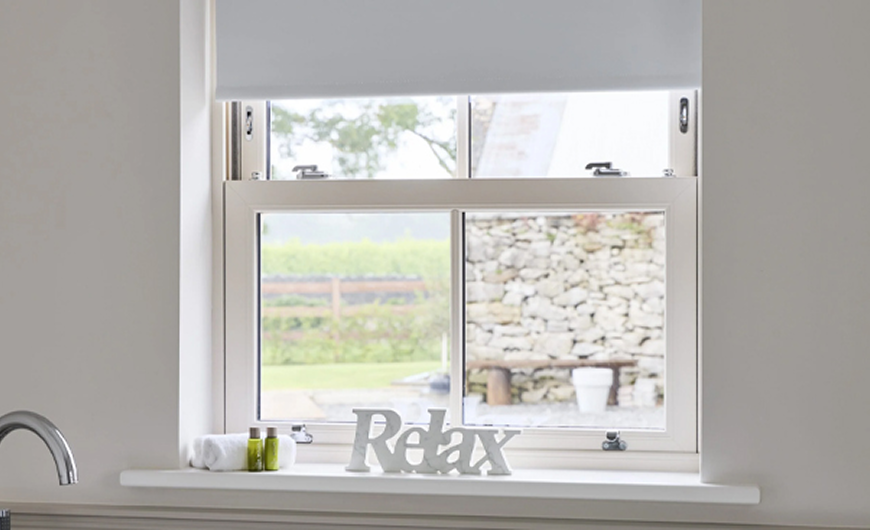 White uPVC vertical sliding window with Relax sign on sill - Senator Windows