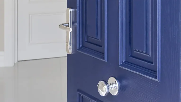 Navy blue composite front door with a chrome lever handle and round knob - Senator Windows