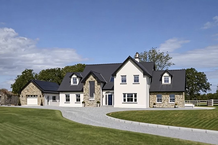 Contemporary detached home featuring energy-efficient white uPVC windows that complement the stone and rendered exterior - Senator Windows