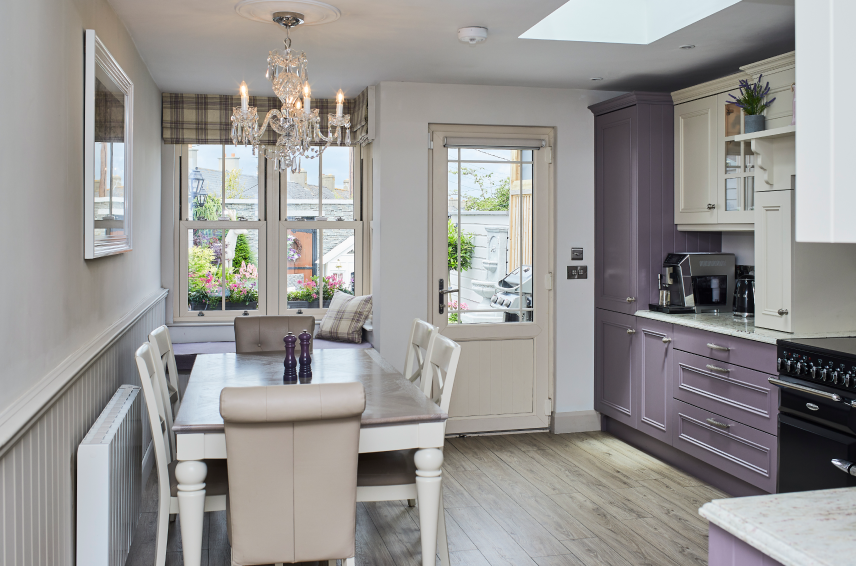 Refurbished kitchen featuring cream uPVC windows and back door leading to a patio area - Senator Windows